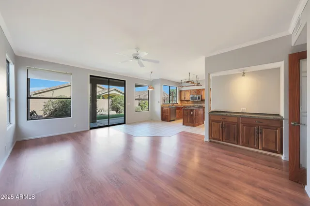 a view of a kitchen with furniture and wooden floor