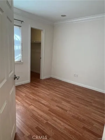 a view of a swimming pool with lawn chairs under an umbrella