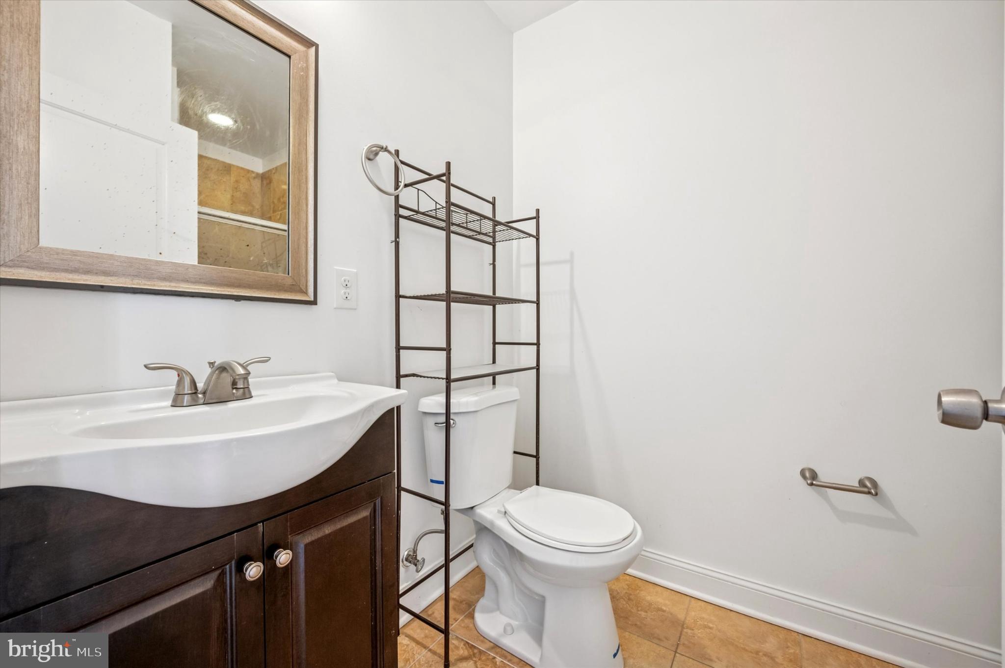 1421 North 18th Street, Unit 3 Philadelphia, PA 19121 - Photo 15 of 16 a bathroom with a sink a toilet and mirror