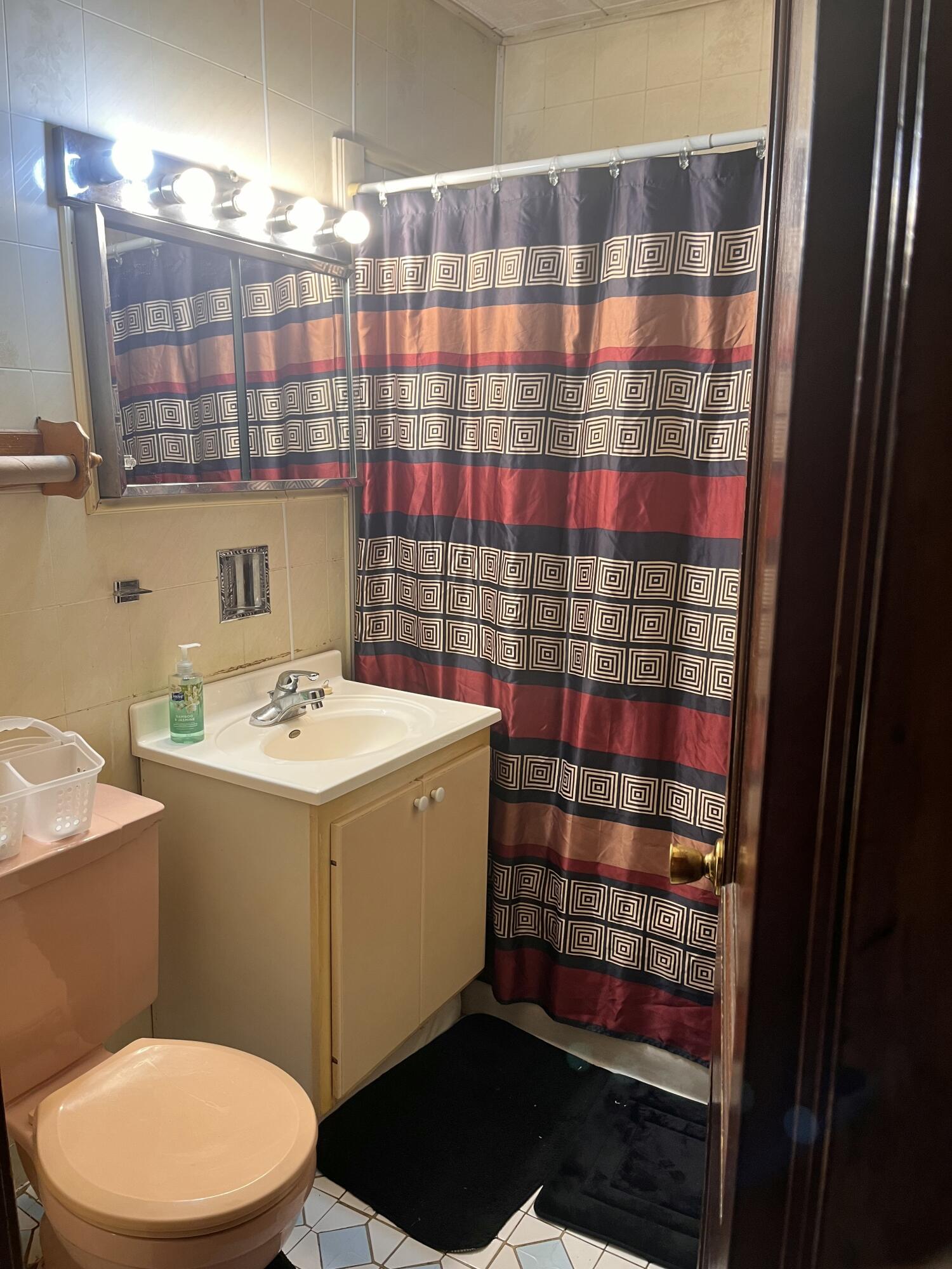 1752 Hayes Street Gary, IN 46404 - Photo 18 of 26 a bathroom with a sink a toilet a shower and a mirror