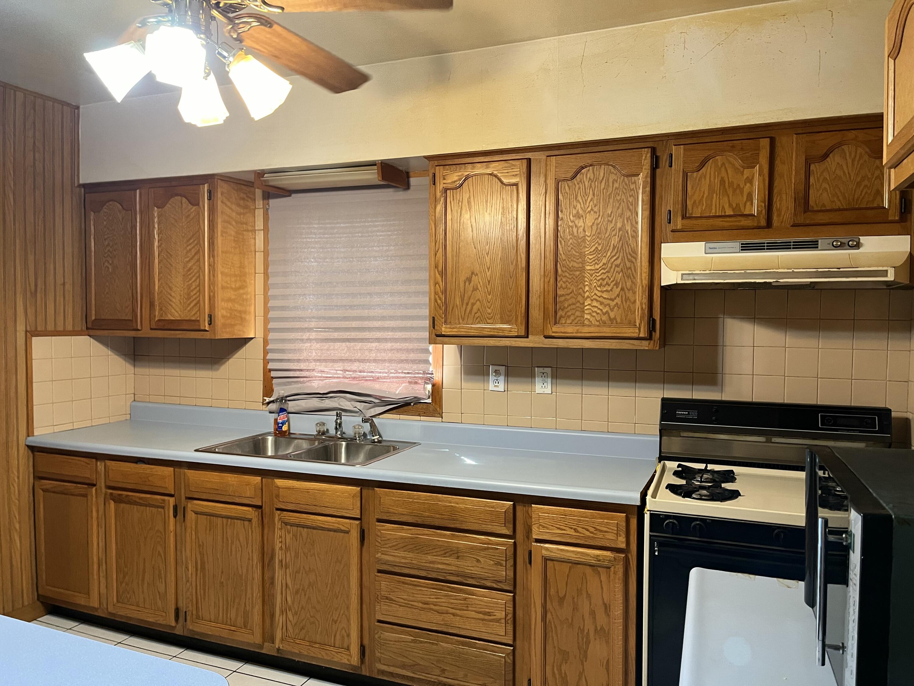 1752 Hayes Street Gary, IN 46404 - Photo 6 of 26 a kitchen with granite countertop a sink a stove and cabinets