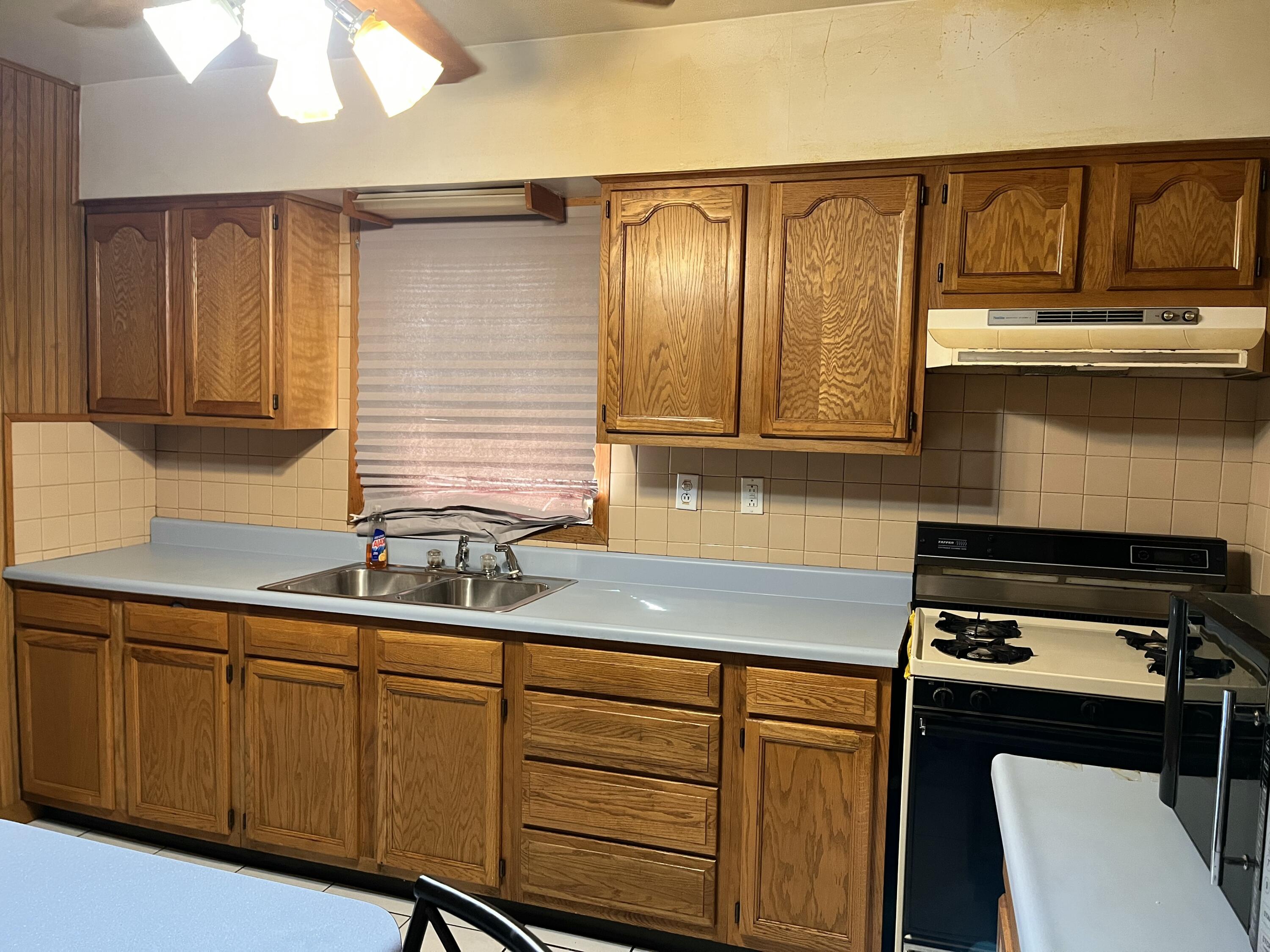 1752 Hayes Street Gary, IN 46404 - Photo 7 of 26 a kitchen with stainless steel appliances granite countertop a sink stove and cabinets