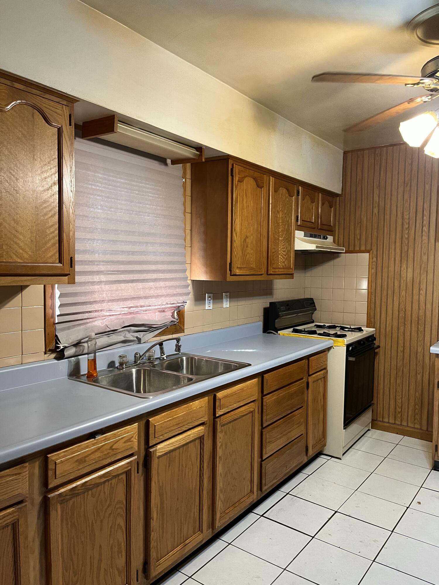 1752 Hayes Street Gary, IN 46404 - Photo 9 of 26 a kitchen with stainless steel appliances granite countertop a sink and a stove