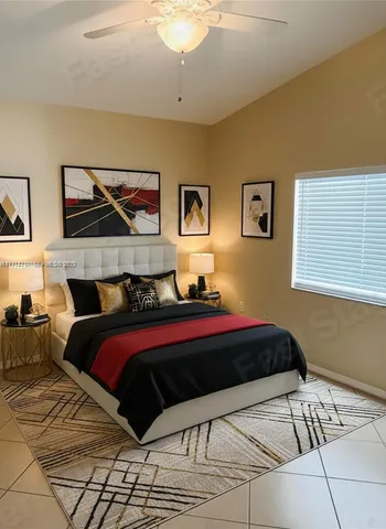 a bedroom with a bed and a painting on the wall