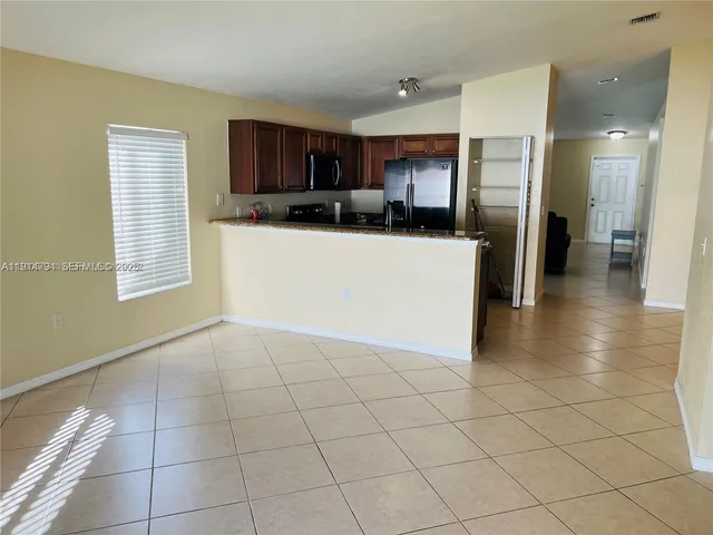 a view of a electric appliances in kitchen and a window