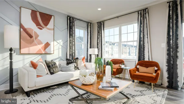 a living room with furniture and floor to ceiling windows