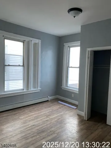 an empty room with closet and windows
