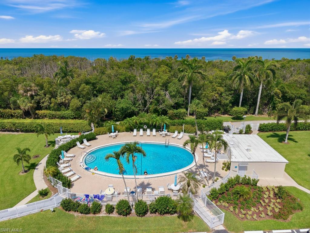 3 Bluebill Avenue, Unit 206 Naples, FL 34108 - Photo 14 of 19 a view of a swimming pool with a yard