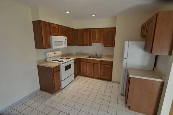 a kitchen with a sink a stove and a microwave