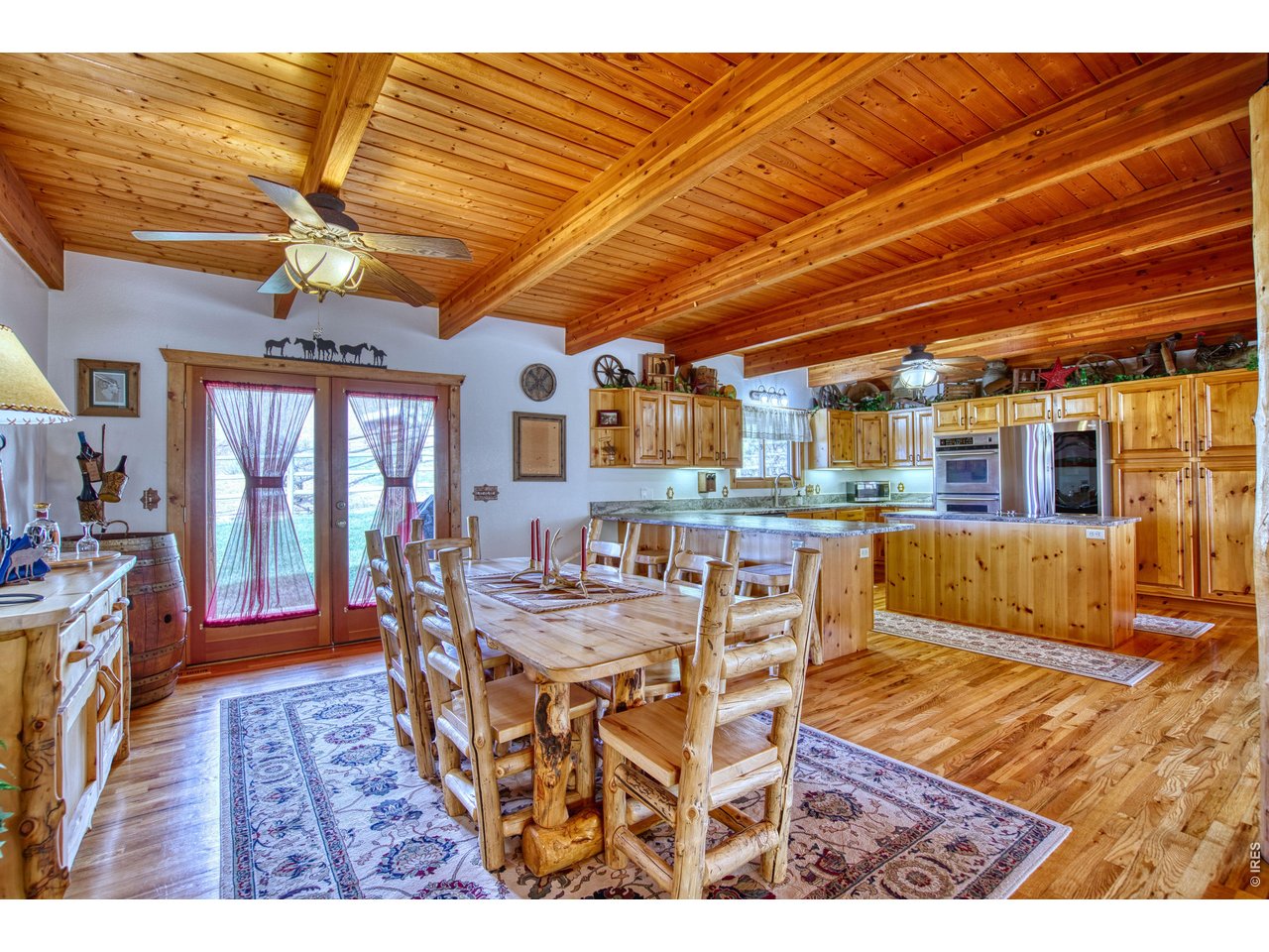 320 Del Monte Road Berthoud, CO 80513 - Photo 12 of 40 a dining room with furniture and a floor to ceiling window