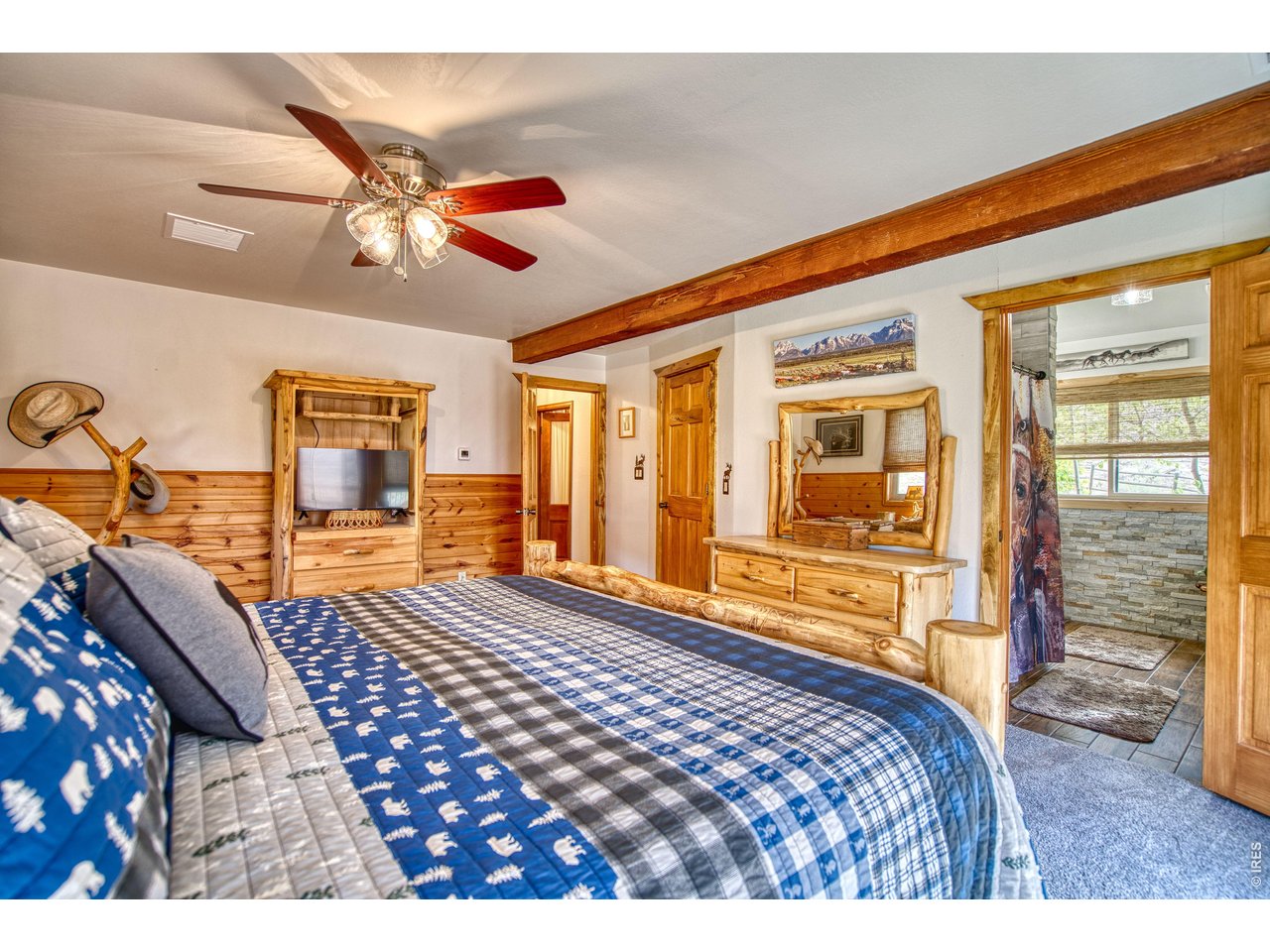320 Del Monte Road Berthoud, CO 80513 - Photo 20 of 40 a bedroom with a bed and wooden floor