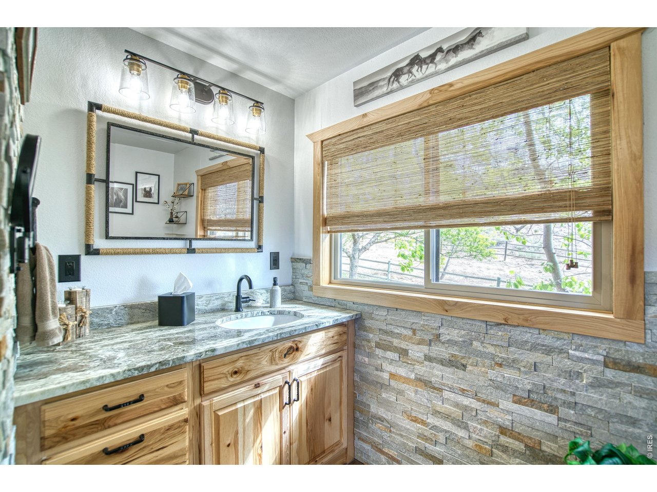 320 Del Monte Road Berthoud, CO 80513 - Photo 22 of 40 a bathroom with a granite countertop sink mirror and a window