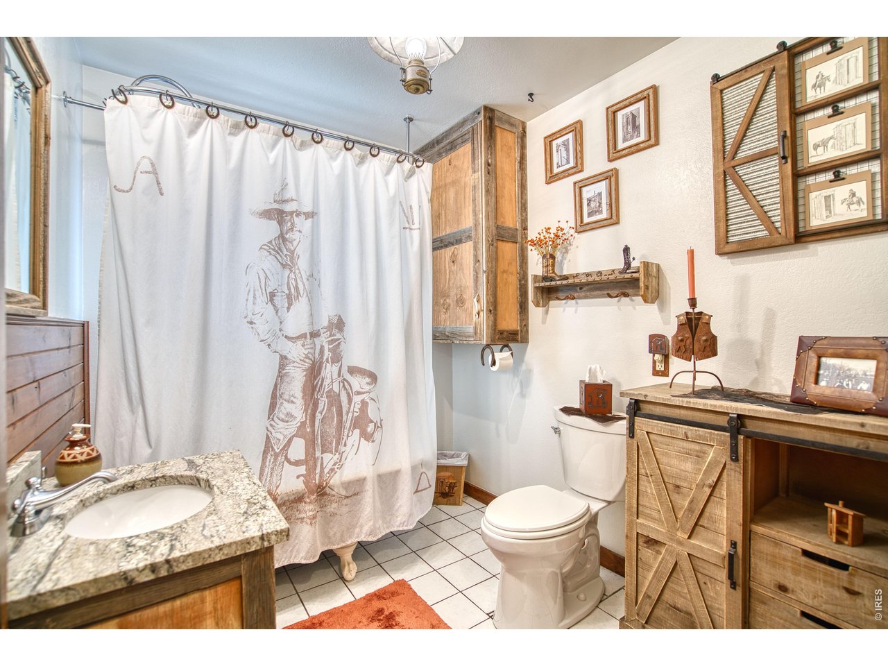 320 Del Monte Road Berthoud, CO 80513 - Photo 27 of 40 a bathroom with a granite countertop sink a toilet and a shower curtain