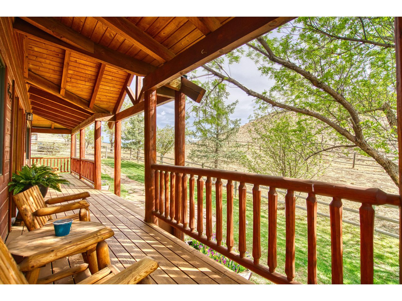320 Del Monte Road Berthoud, CO 80513 - Photo 7 of 40 a balcony with wooden floor and furniture