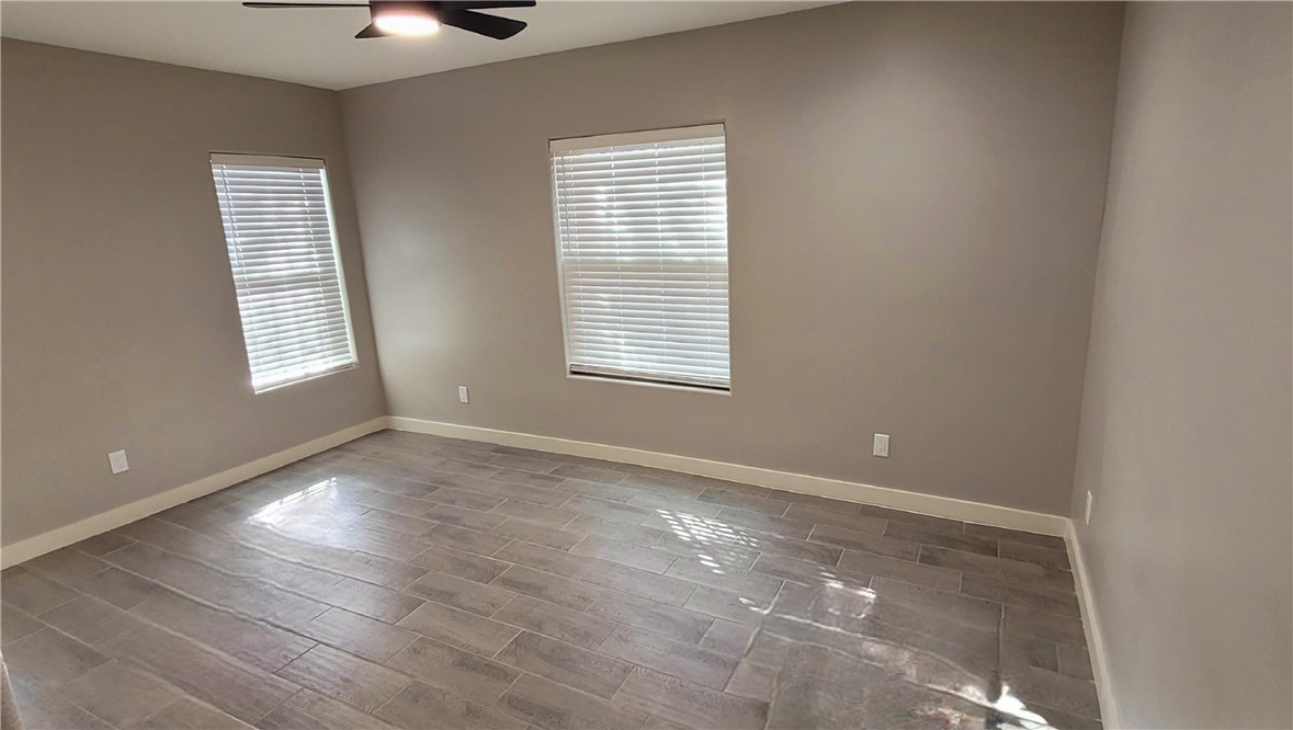 104 Hub Street Alice, TX 78332 - Photo 12 of 15 a view of an empty room with wooden floor and a window