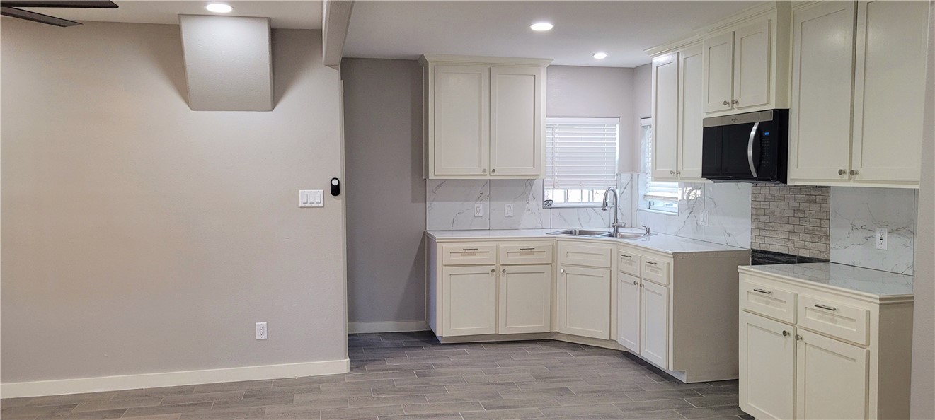 104 Hub Street Alice, TX 78332 - Photo 6 of 15 a kitchen with white cabinets and sink