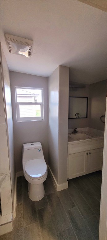 104 Hub Street Alice, TX 78332 - Photo 8 of 15 a bathroom with a toilet sink and mirror