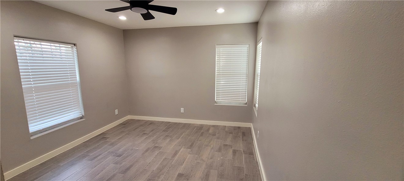 104 Hub Street Alice, TX 78332 - Photo 10 of 15 an empty room with a window and a ceiling fan