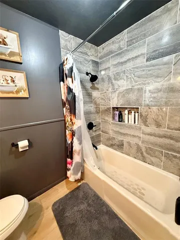 a bathroom with a bathtub and shower