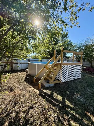 a view of a roof deck with wooden floor and fence