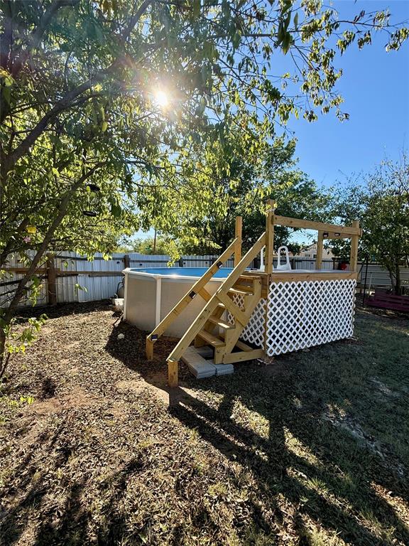 704 Post Street Coleman, TX 76834 - Photo 21 of 40 a view of a roof deck with wooden floor and fence