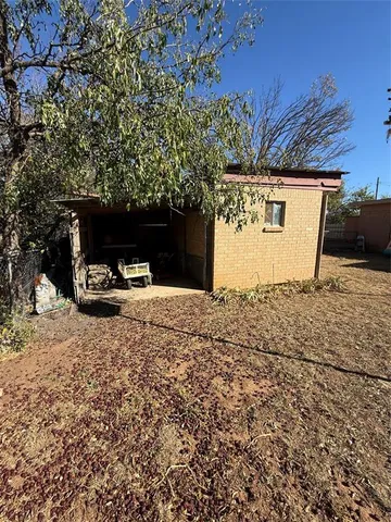 a view of a patio with table and chairs with wooden floor and fence