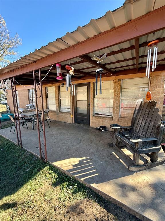 704 Post Street Coleman, TX 76834 - Photo 31 of 40 a view of a patio with table and chairs with wooden floor and fence