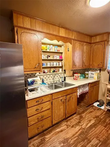 a kitchen with stainless steel appliances a sink and cabinets