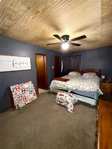 a bedroom with bed and a chandelier