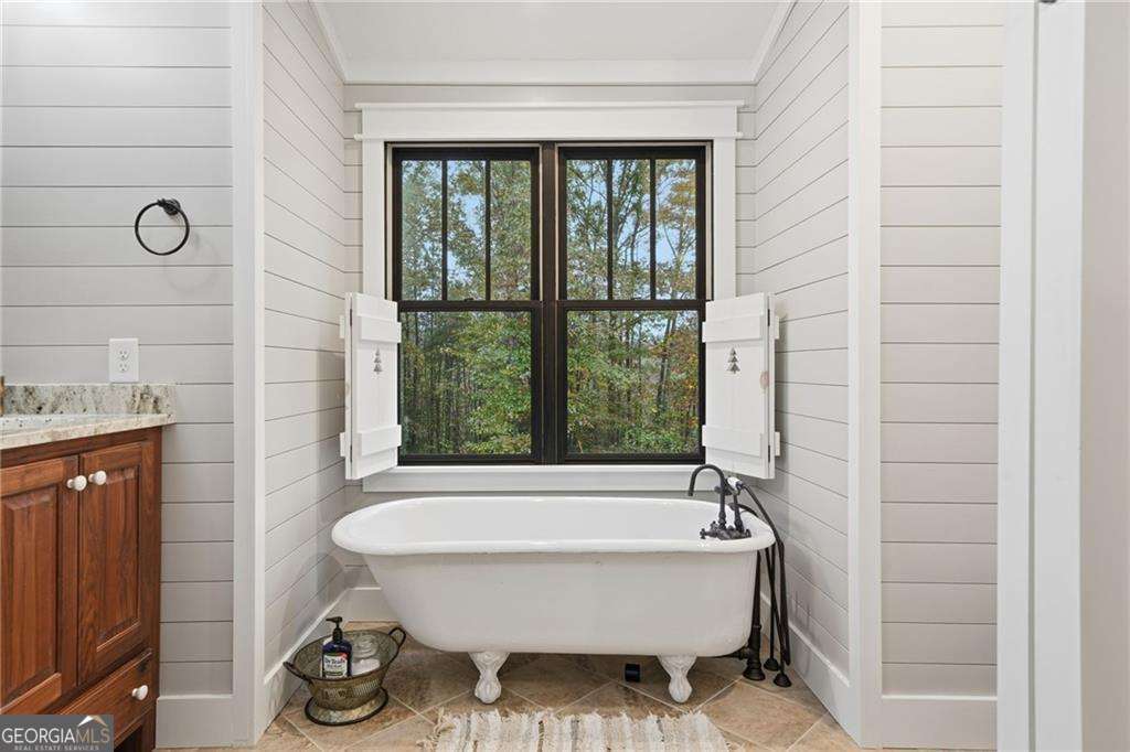 2197 Damascus Road Ball Ground, GA 30107 - Photo 26 of 39 a bathroom with a bathtub and window