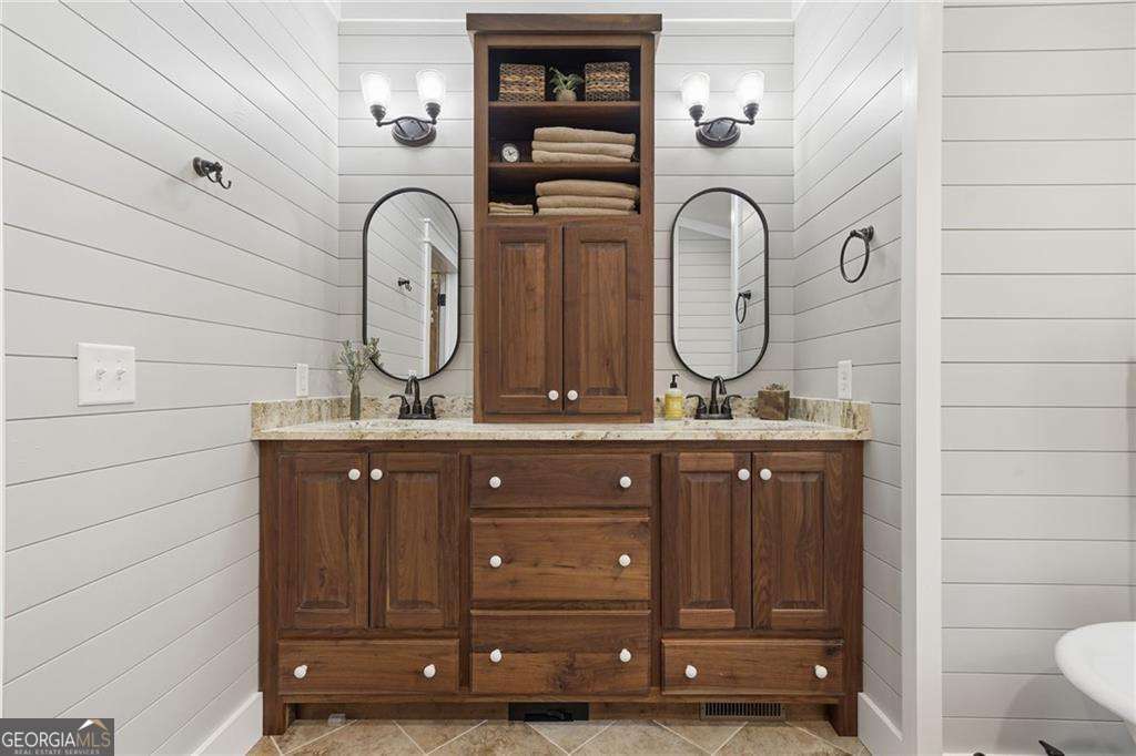 2197 Damascus Road Ball Ground, GA 30107 - Photo 27 of 39 a bathroom with a granite countertop double vanity sink and a mirror