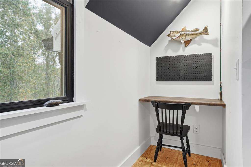 2197 Damascus Road Ball Ground, GA 30107 - Photo 37 of 39 a living room with a chair and a flat screen tv