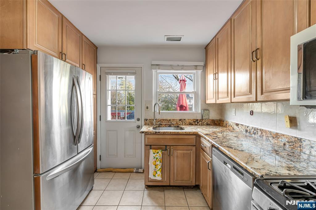 17 Porter Road West Orange, NJ 07052 - Photo 14 of 32 a kitchen with stainless steel appliances granite countertop a refrigerator sink and stove