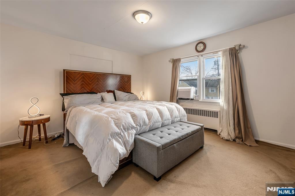 17 Porter Road West Orange, NJ 07052 - Photo 16 of 32 a bed sitting in a bedroom next to a window