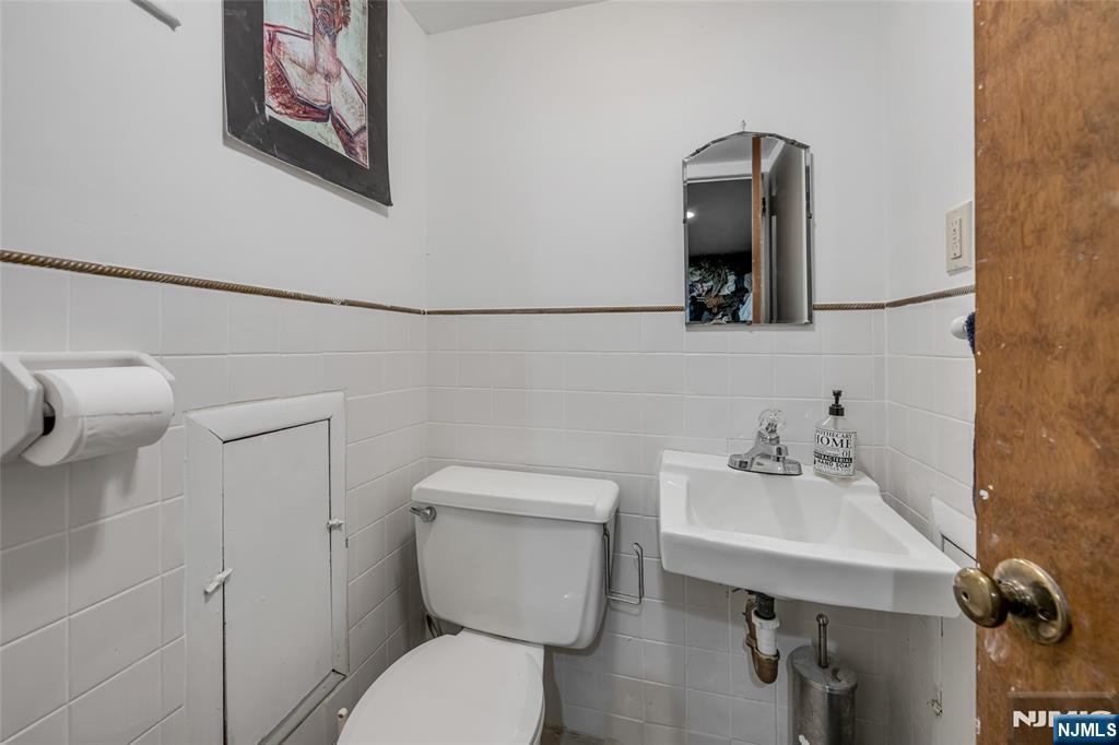 17 Porter Road West Orange, NJ 07052 - Photo 25 of 32 a bathroom with a toilet a sink and mirror