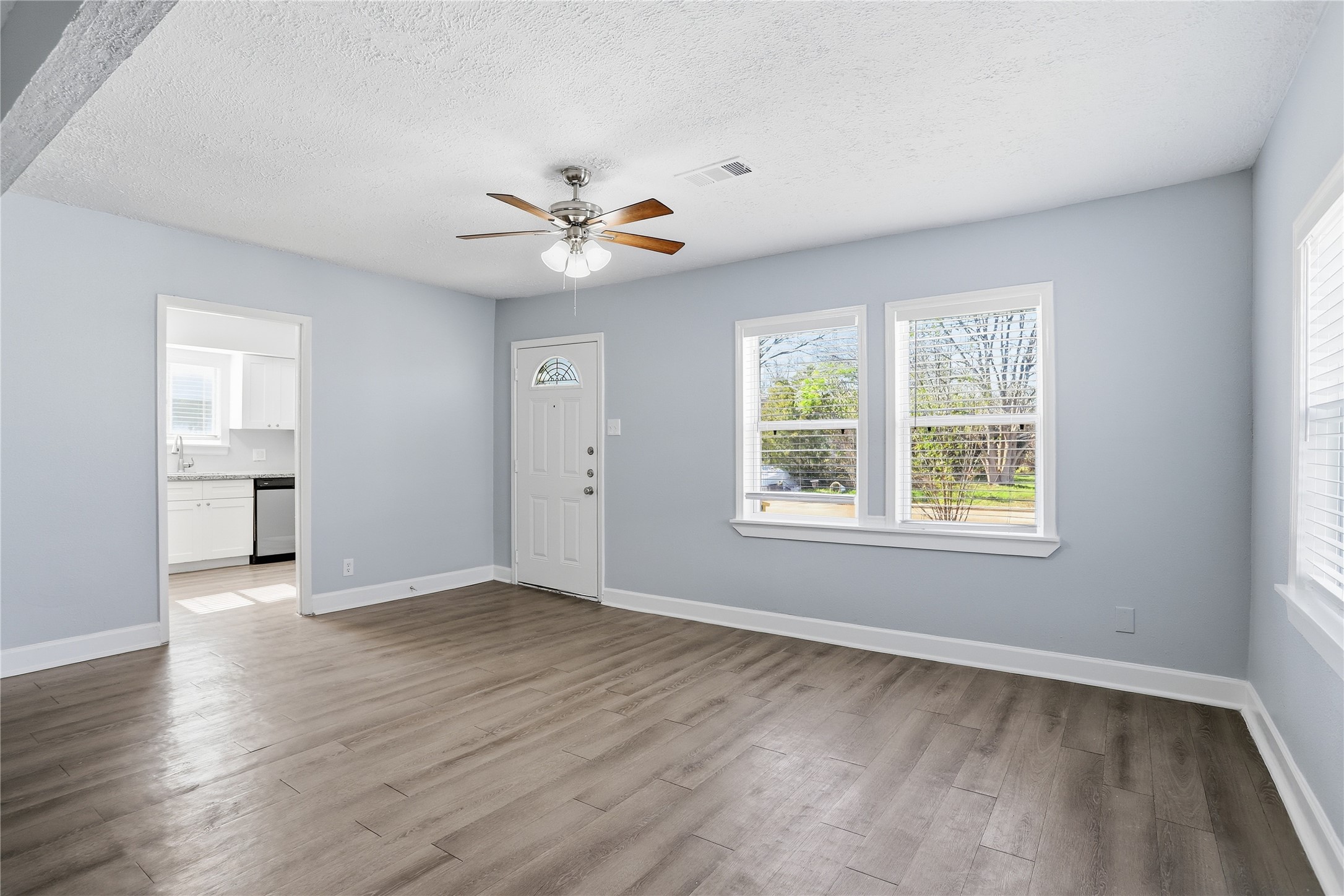 1707 Johnson Street Pasadena, TX 77502 - Photo 11 of 45 a view of an empty room with a window and wooden floor