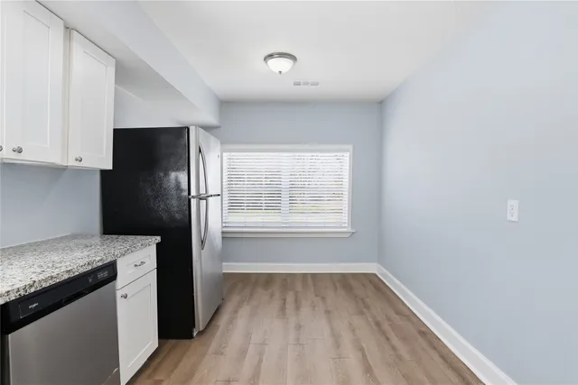 a kitchen with a refrigerator and a sink