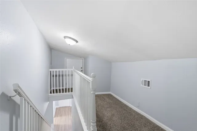 a view of a hallway with stairs