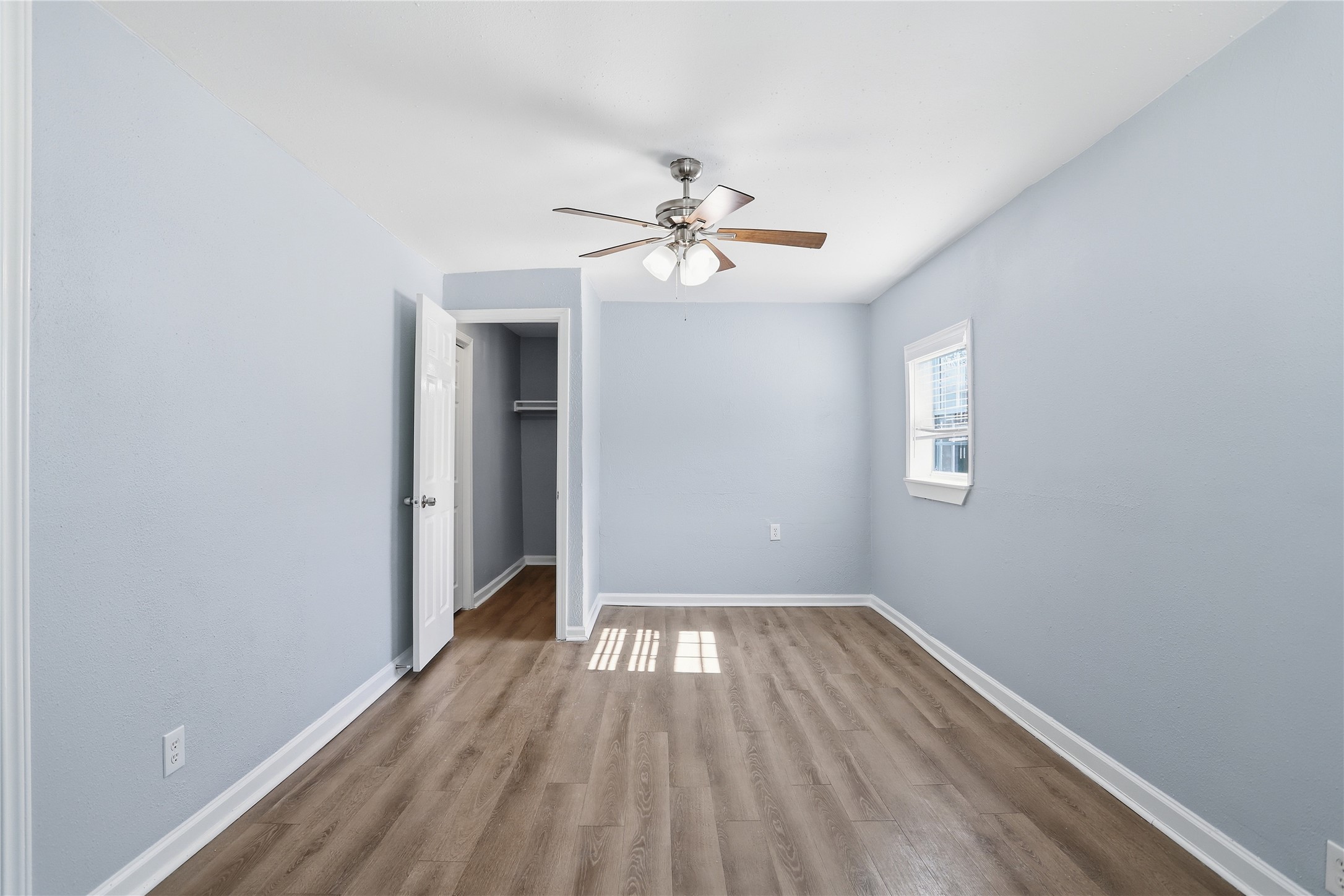 1707 Johnson Street Pasadena, TX 77502 - Photo 21 of 45 wooden floor in an empty room with a window