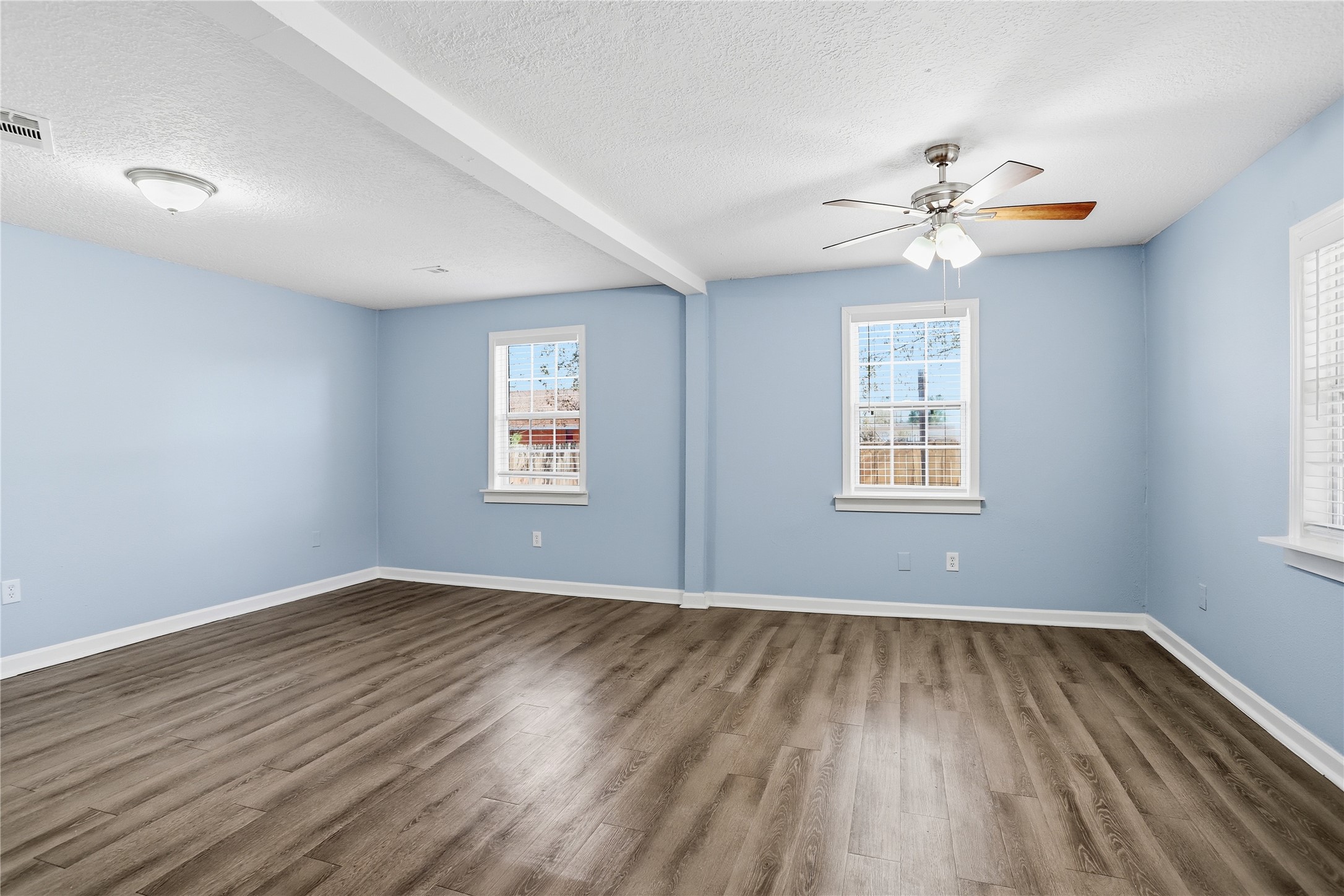 1707 Johnson Street Pasadena, TX 77502 - Photo 24 of 45 a view of empty room with wooden floor and fan