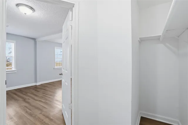 a view of hallway with wooden floor