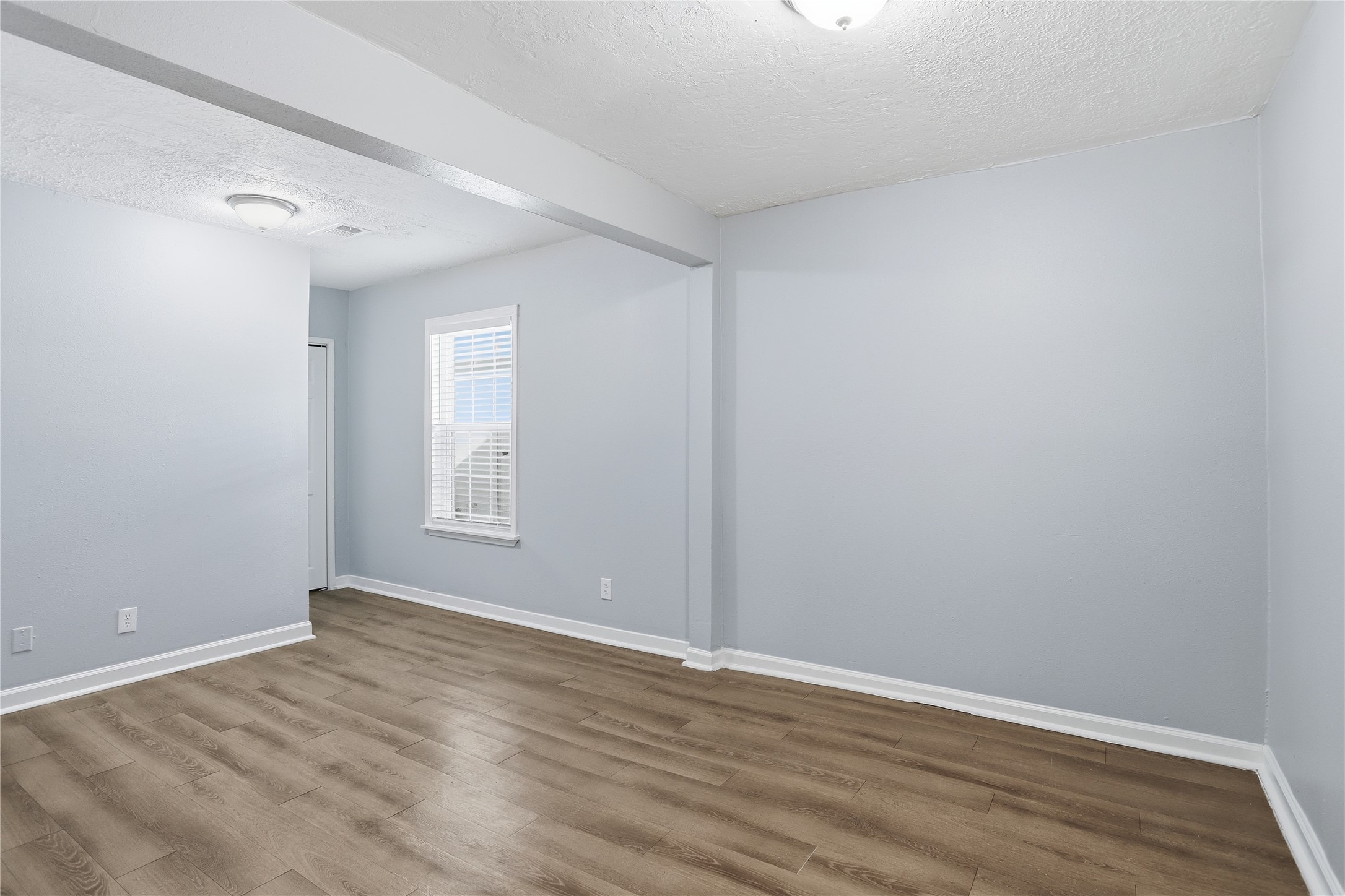 1707 Johnson Street Pasadena, TX 77502 - Photo 28 of 45 a view of an empty room with wooden floor and a window