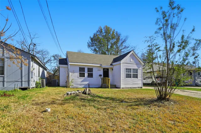 a house that has a tree in front of it