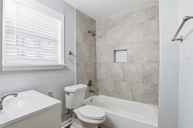 a bathroom with a sink a toilet and a bathtub