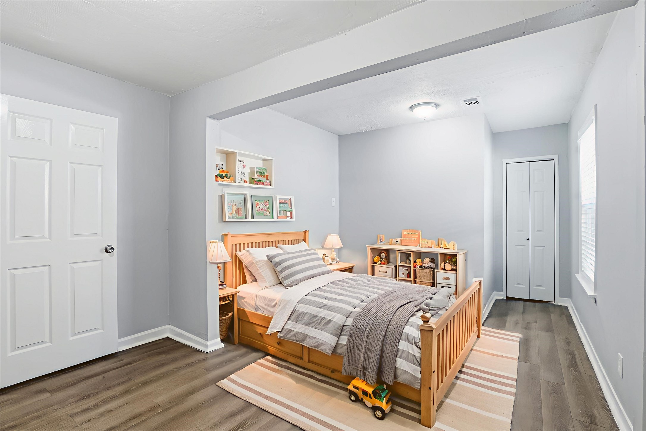 1707 Johnson Street Pasadena, TX 77502 - Photo 9 of 45 a bedroom with a bed and wooden floor