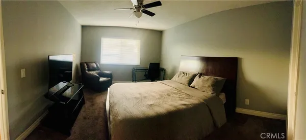 a bedroom with a bed and a lamp