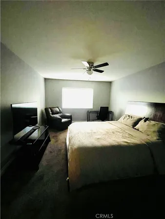 a bedroom with a bed and a tv