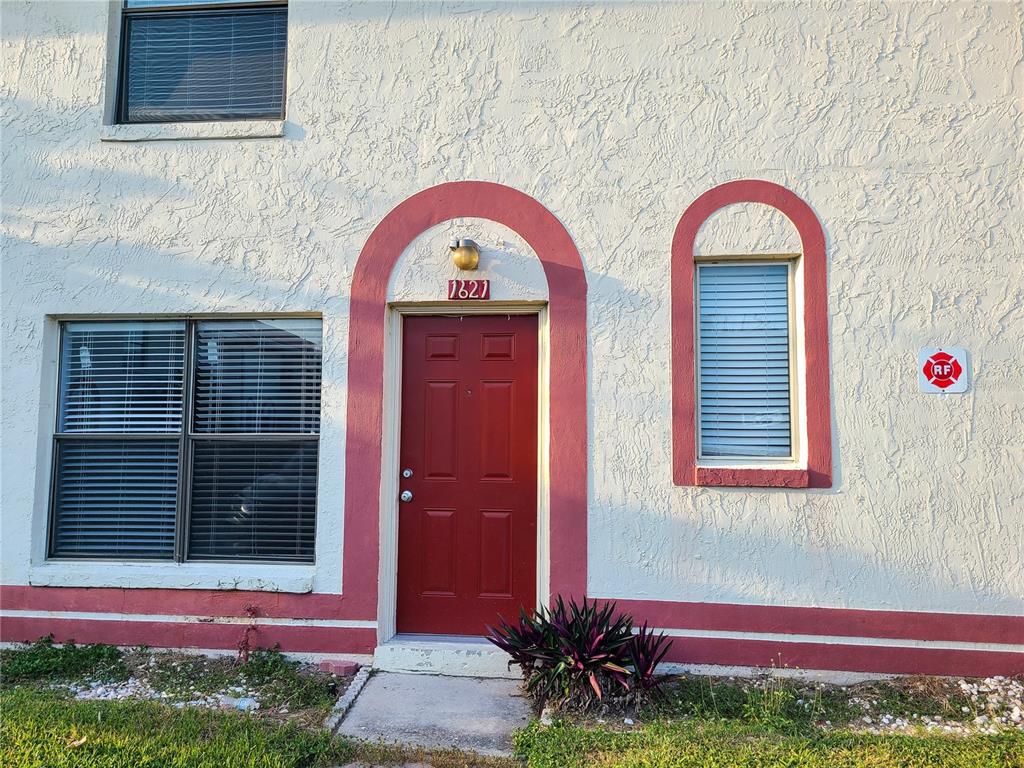 1621 Sandy Point Square, Unit 61 Orlando, FL 32807 - Photo 1 of 1 a view of front of a house with a yard