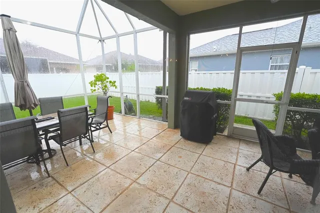 a view of a dining room with furniture and a potted plant