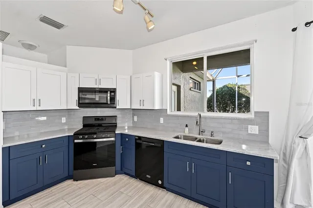 a kitchen with a sink stove top oven and cabinets